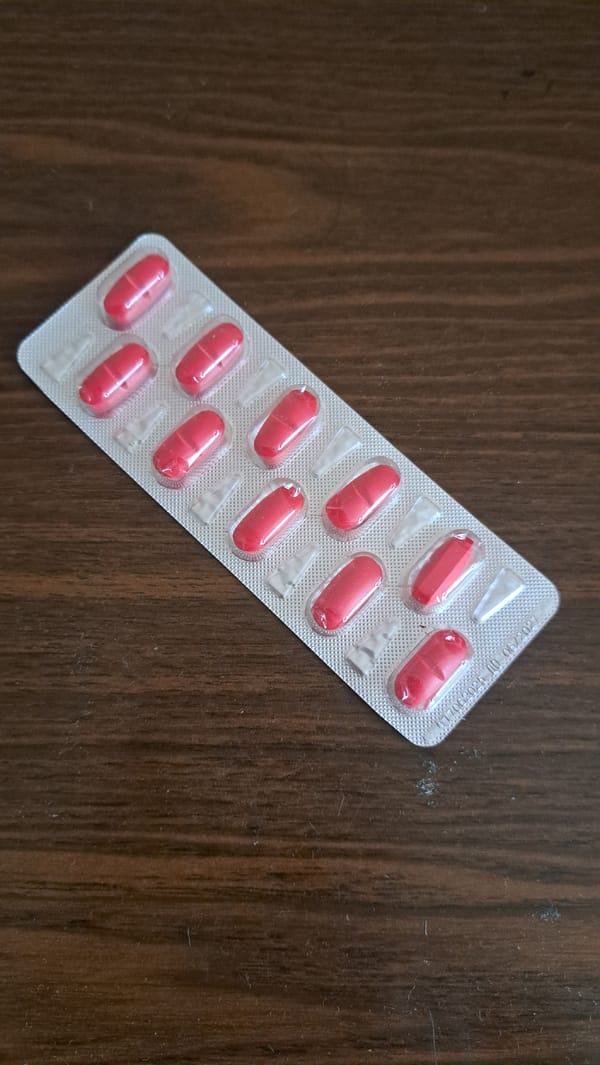 Pills and a hot drink, close up