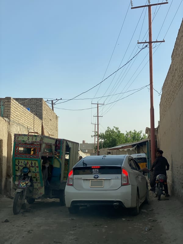 Daily life captured on Kandahar streets, traditional dress observed