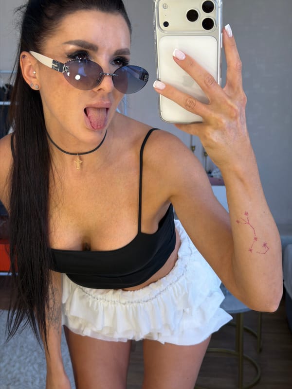 Casual home selfie with sunglasses and a playful expression