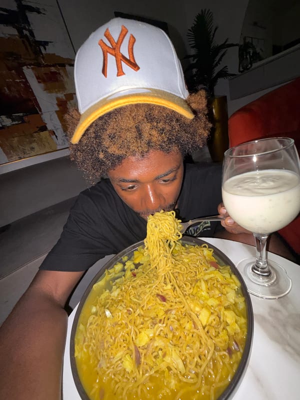 Young man eating noodles documented in Igboefon, Nigeria
