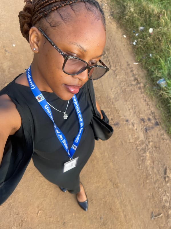 University of Jos student takes selfies on a dirt path in Nigeria