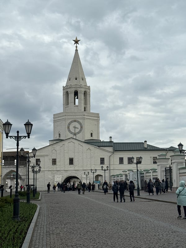 Tourists visit historic Kazan tower, horse carriage operates nearby