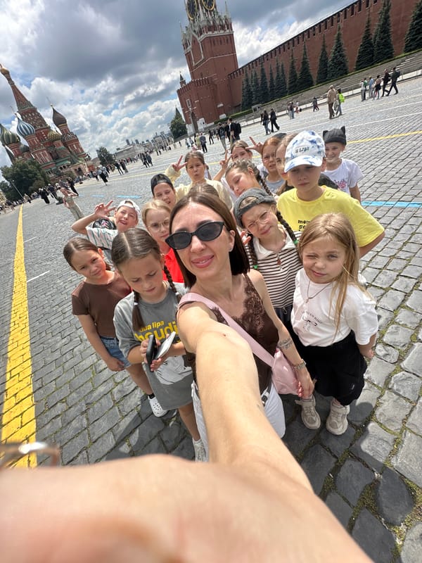Group selfie at a Moscow plaza landmark, summer 2026