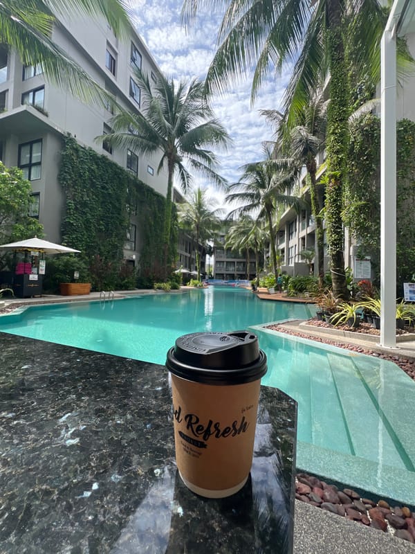 Poolside coffee and tropical flowers at a Phuket resort