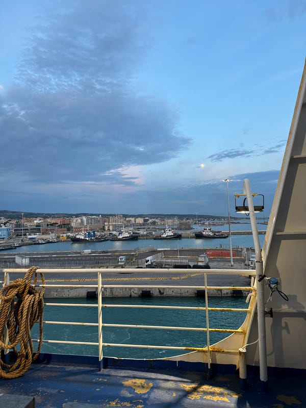 Ferry passengers document evening harbor activity in Civitavecchia