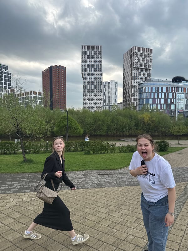 Two women pose playfully on Yekaterinburg walkway