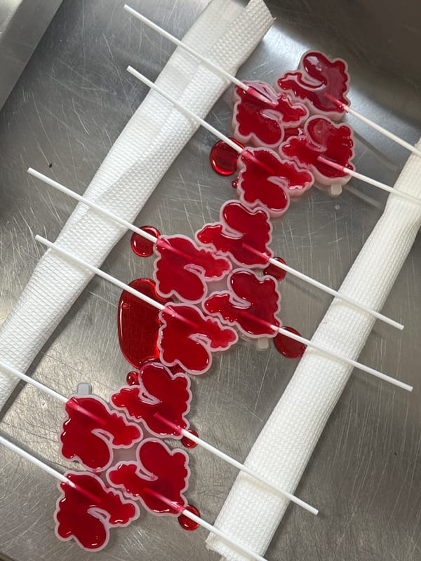 Cyrillic letter-shaped lollipops displayed on tray in Perm