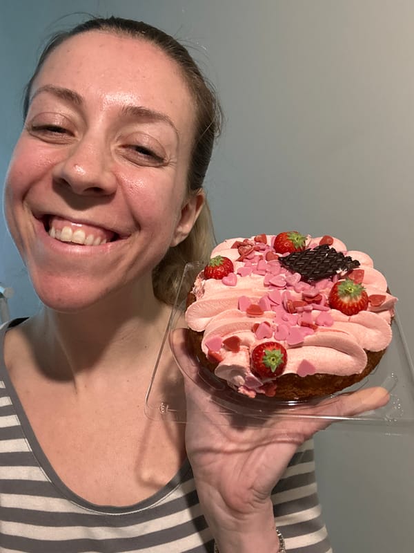 Woman displays strawberry cake, tends garden in Amsterdam afternoon
