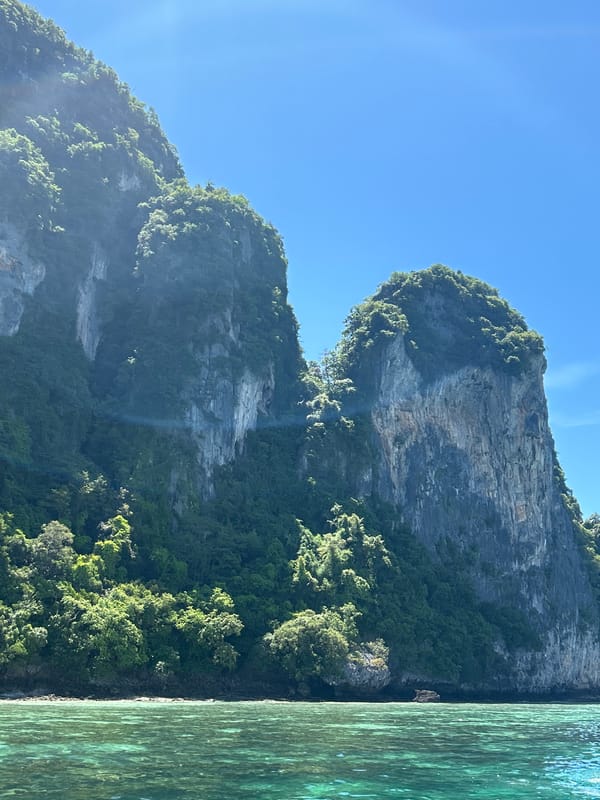 Tourist boats operate in Ao Nang waters with swimmers