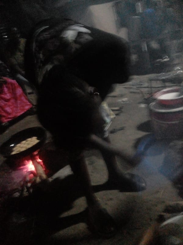 Nighttime street cooking over open fire in Langtang, Nigeria