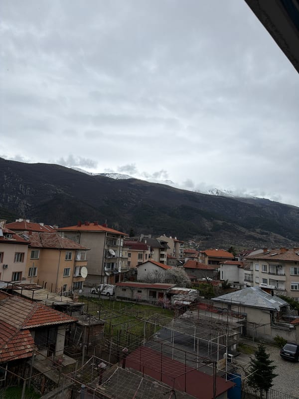Overcast view captures Karlovo's residential landscape against mountain backdrop