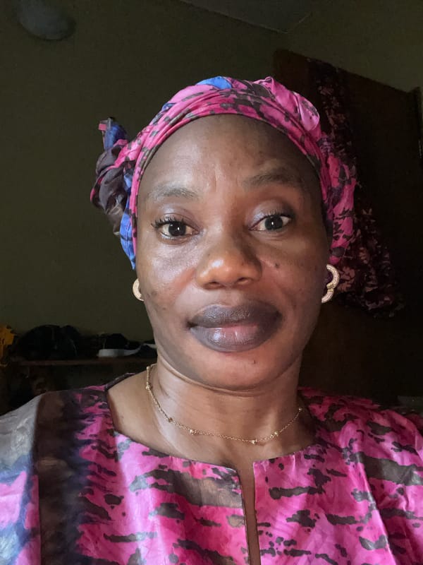 Portrait captured of woman in patterned headwrap in Narayi
