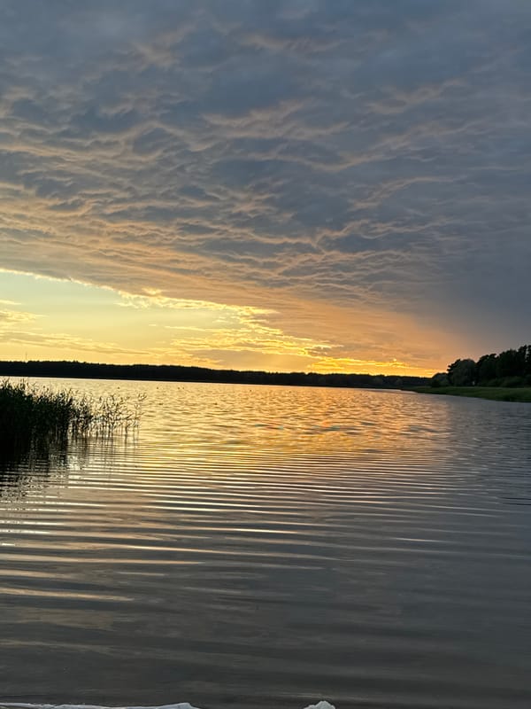 Sunset at a calm Tallinn lakeside, midsummer evening