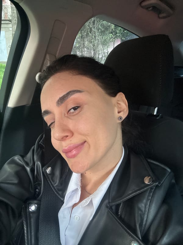 Person photographed resting in parked car in Tbilisi