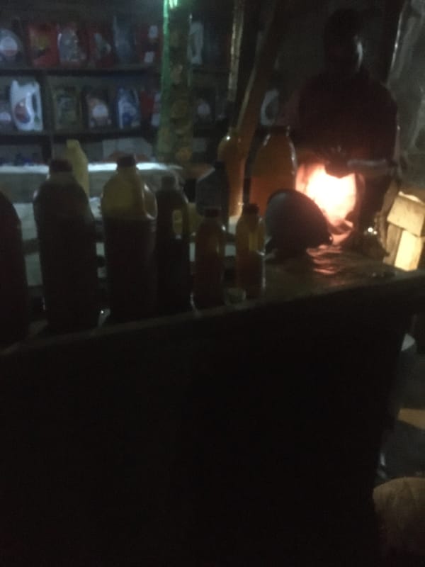 Blurry nighttime scene captured inside Dutsen Alhaji shop