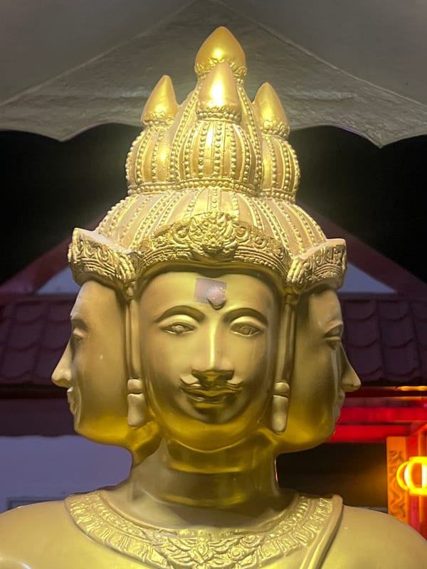 Golden four-faced Brahma statue at a Pa Khlok shrine
