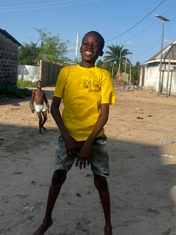 Kids playing and doing tricks outside in Badagry