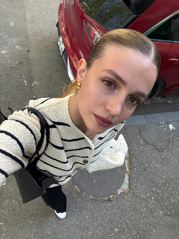 Woman Takes Upward-Angled Selfie in Downtown Tbilisi