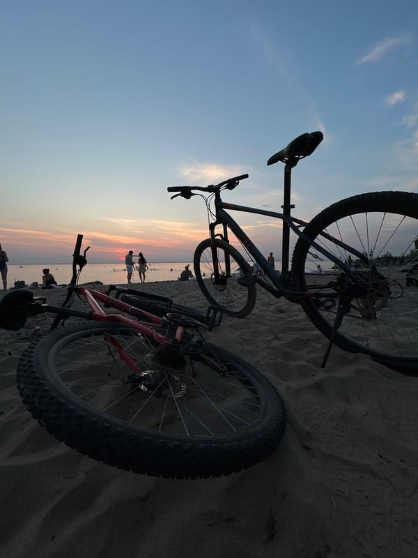 Sunset swim session at a Berdsk beach, bikes parked on sand