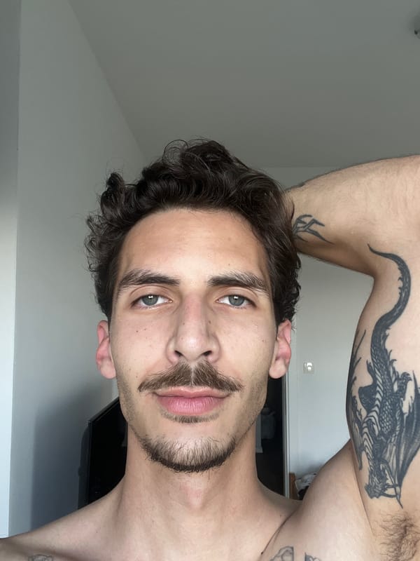 Tattooed man observed in Rafailovići Montenegro interior setting