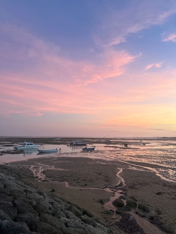 Vibrant sunset observed over Denpasar coast during low tide