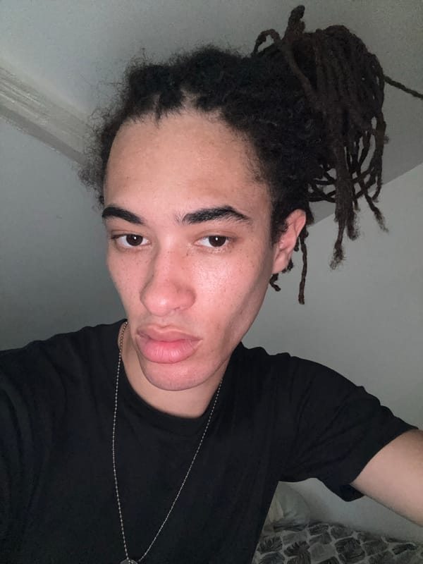 Low-angle selfie session in Paris, dreadlocks and silver necklace