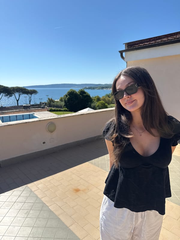 Woman poses on lakeside terrace in Bracciano, Italy