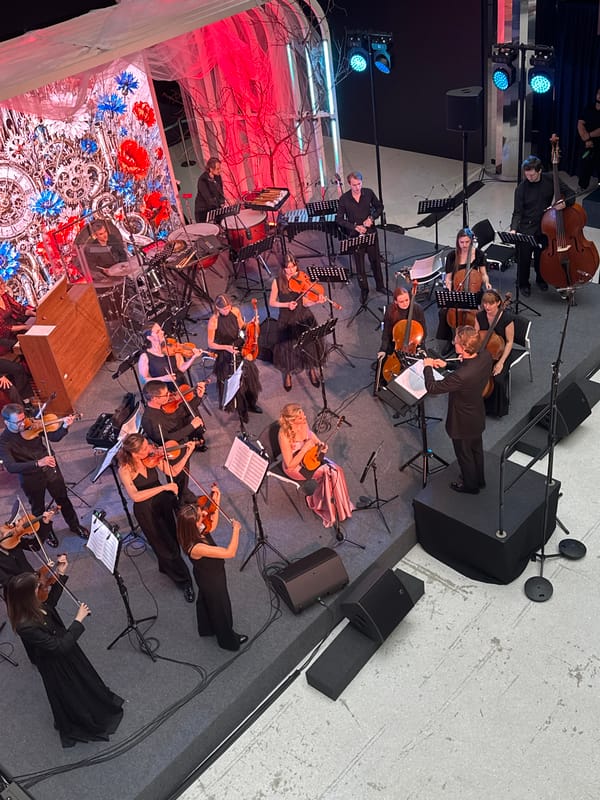 Overhead view of a full orchestra performing live on stage