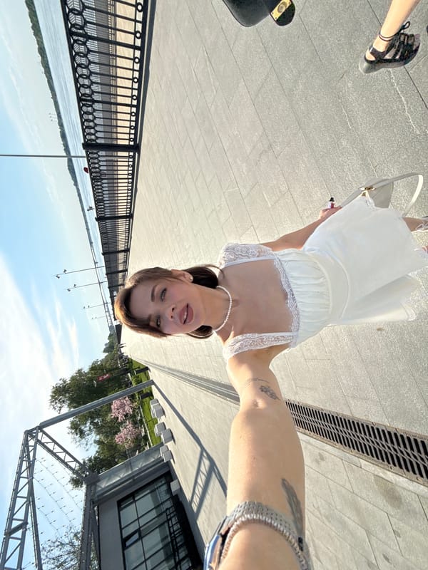 Woman photographs spring outing along Perm's Kama River embankment