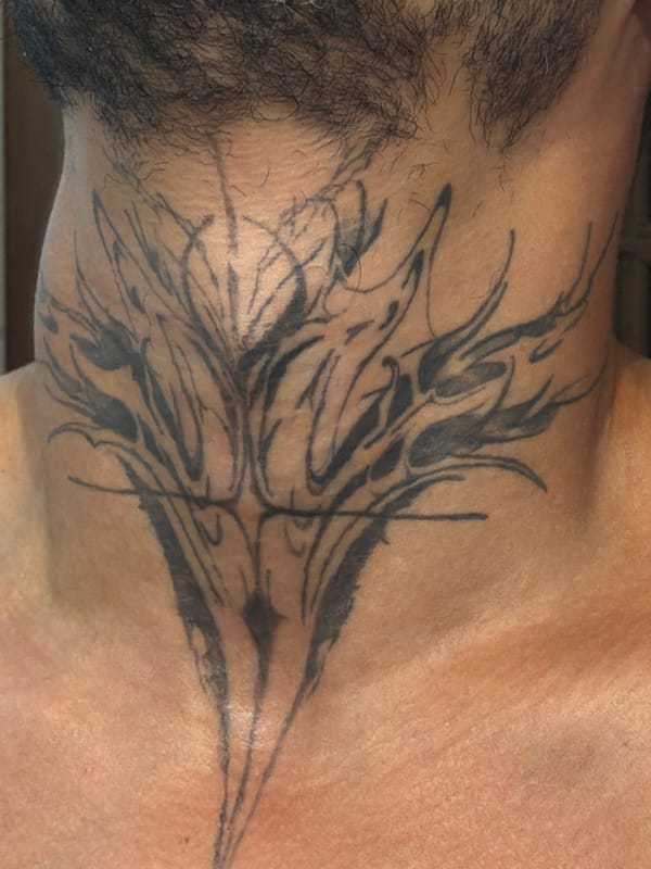 Detailed tattoo shots in Milan: neck piece and butterfly hand ink